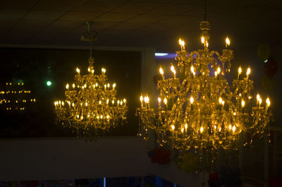 Illuminated chandelier hanging at night