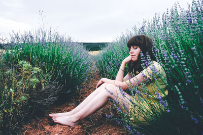 Young woman sitting on field