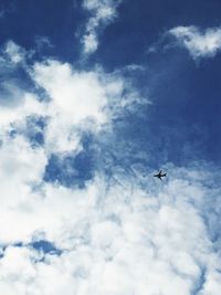 Low angle view of airplane flying in sky