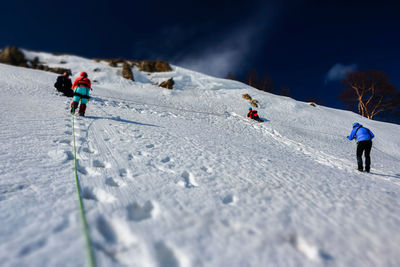 People skiing on snow covered mountain