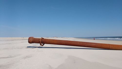 Lifeguard hut on beach against clear sky
