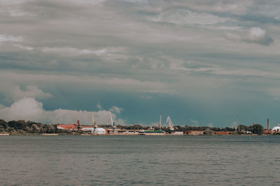 Sailboats on sea by buildings against sky,seaport, sky before the rain, storm