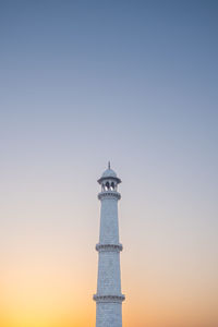 Low angle view of lighthouse against sky during sunset