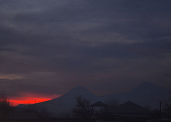 Scenic view of silhouette mountains against sky during sunset