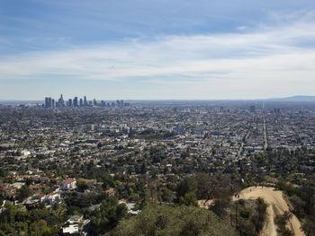 Aerial view of city buildings against sky