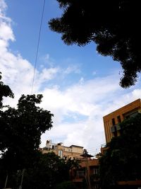 Low angle view of buildings against cloudy sky