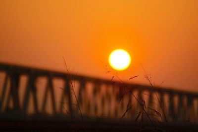 View of sun shining through landscape during sunset