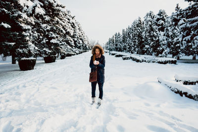 Portrait of man standing on snow field