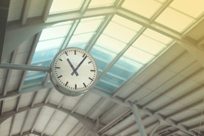 Low angle view of clock on ceiling