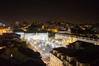 Illuminated cityscape against sky at night