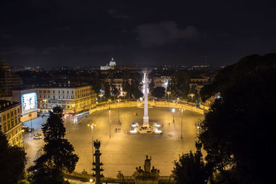 High angle view of city lit up at night