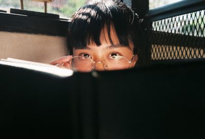 Portrait of woman with open book at home