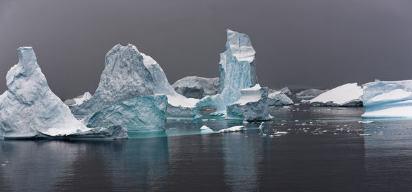 Colourful iceberg sculptures in antarctic ocean near horseshoe island