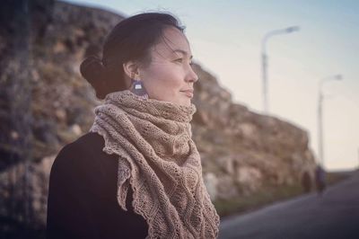 Side view of smiling woman looking away