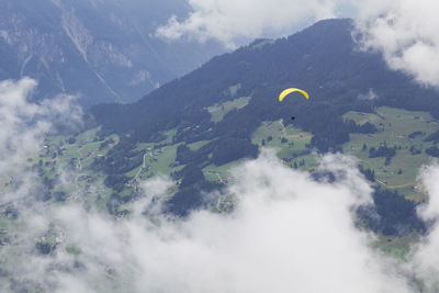 Aerial view of clouds over mountain against sky