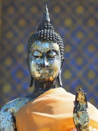 Close-up of statue against temple outside building