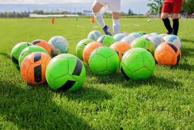 Soccer gears on green grass prepared for training in kids football academy. popular sport activity