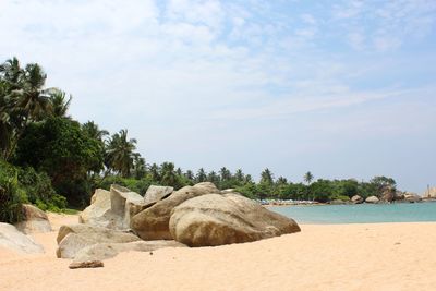 Rocks on beach against sky