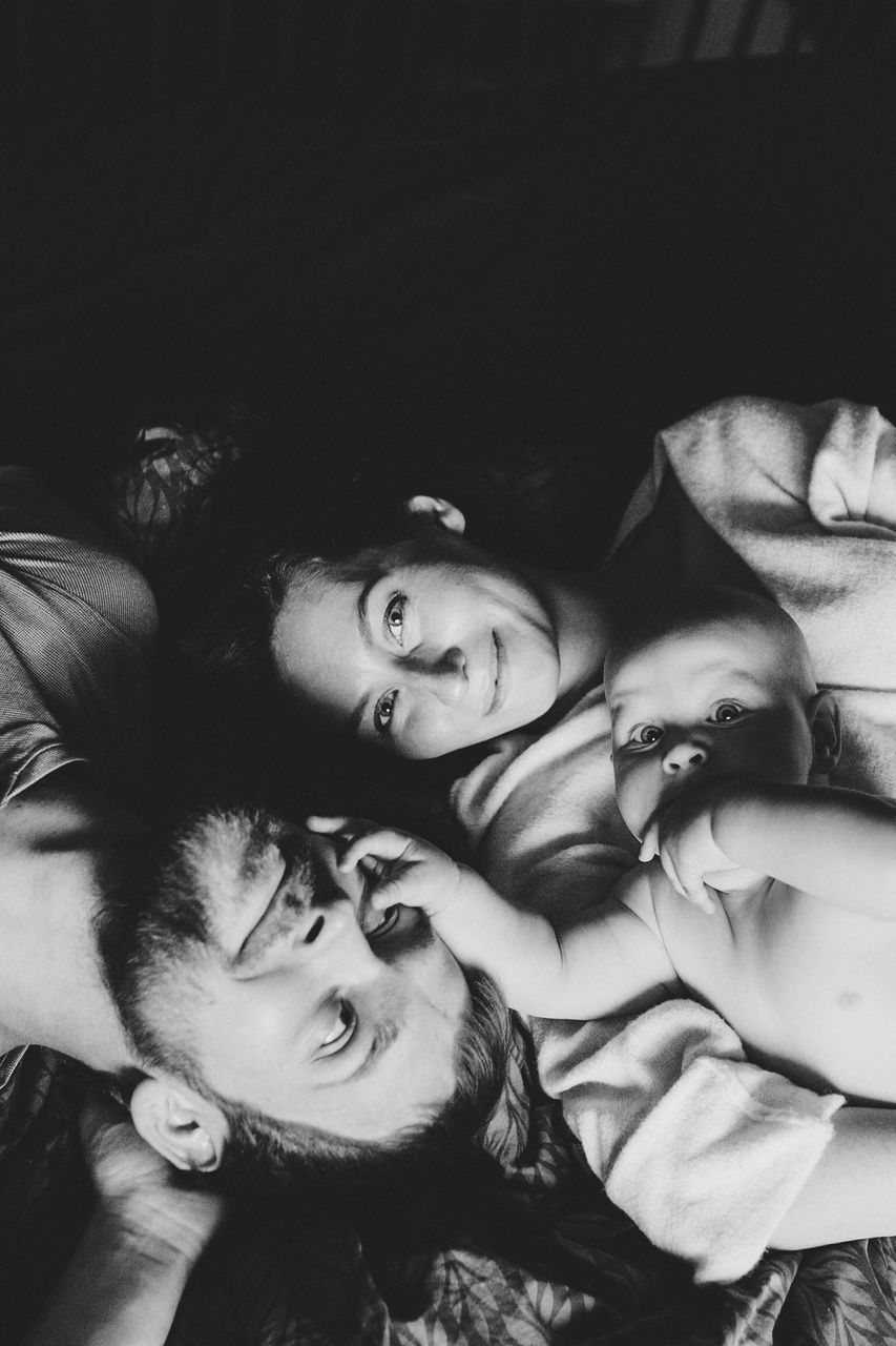 PORTRAIT OF MOTHER AND DAUGHTER IN BEDROOM