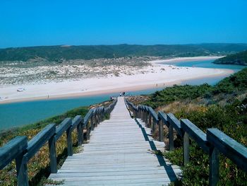 Narrow walkway leading to sea