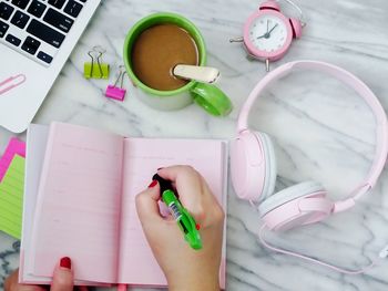 High angle view of woman holding pink at home