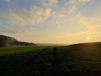 Scenic view of field against sky during sunset