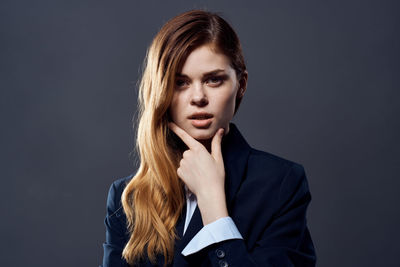 Portrait of a beautiful young woman over black background