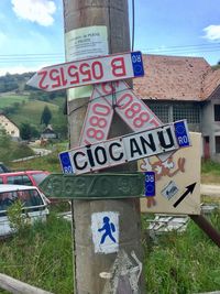 Information sign on road against sky