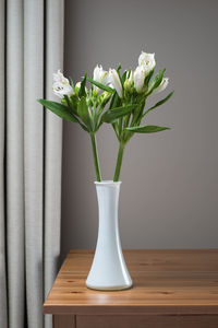 Close-up of white flower vase on table