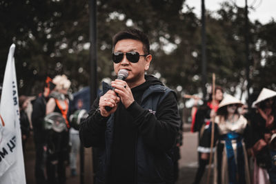 Portrait of young man wearing sunglasses standing outdoors