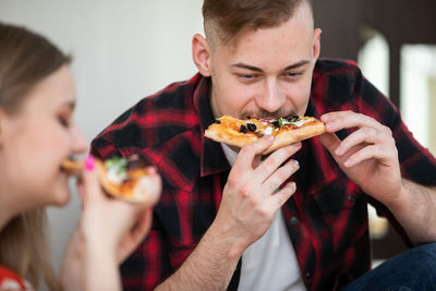 Close-up of man eating food at home