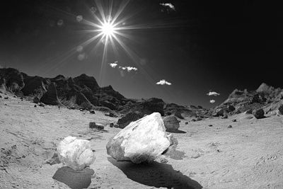Scenic view of rocks against sky on sunny day