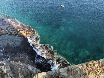 High angle view of rocks by sea