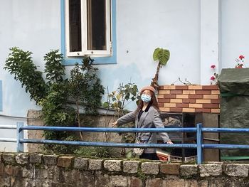 A girl walking around neighbourhood in mask