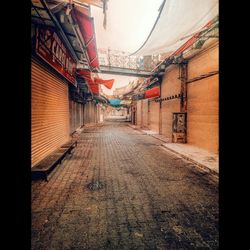 Empty alley amidst buildings