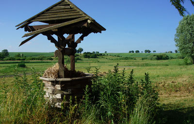 Traditional windmill on field against sky