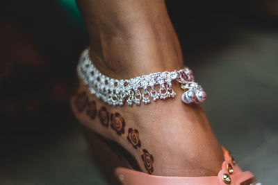 Low section of bride wearing anklet