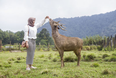 Full length of woman standing on field