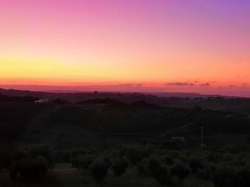 Scenic view of silhouette landscape against romantic sky at sunset