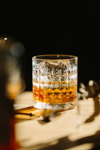 Close-up of glass with bourbon whiskey on table