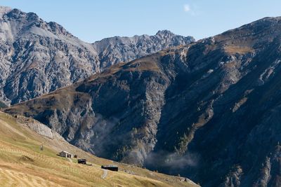 Scenic view of land and mountains against sky