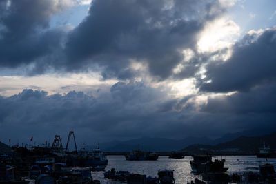 Sailboats in sea against sky during sunset