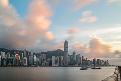 Panoramic view of bay and buildings against sky