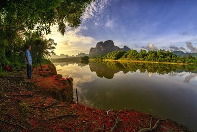 Reflection of trees in lake against sky