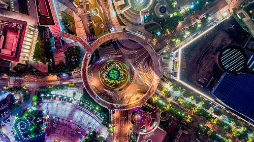 High angle view of city lit up at night