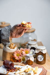 Midsection of woman with bouquet on table