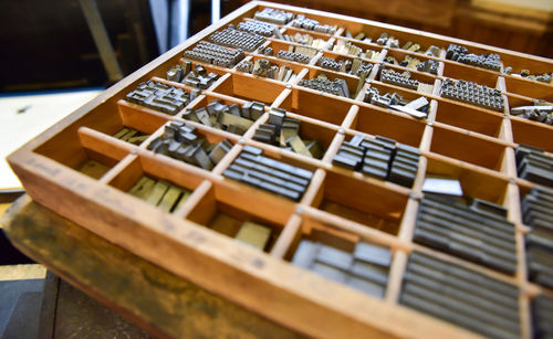 High angle view of hand tools in wooden container