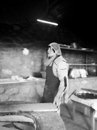 Side view of woman working in workshop