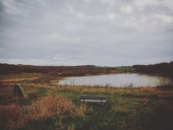 Scenic view of lake against cloudy sky