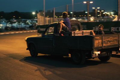 People standing on road at night